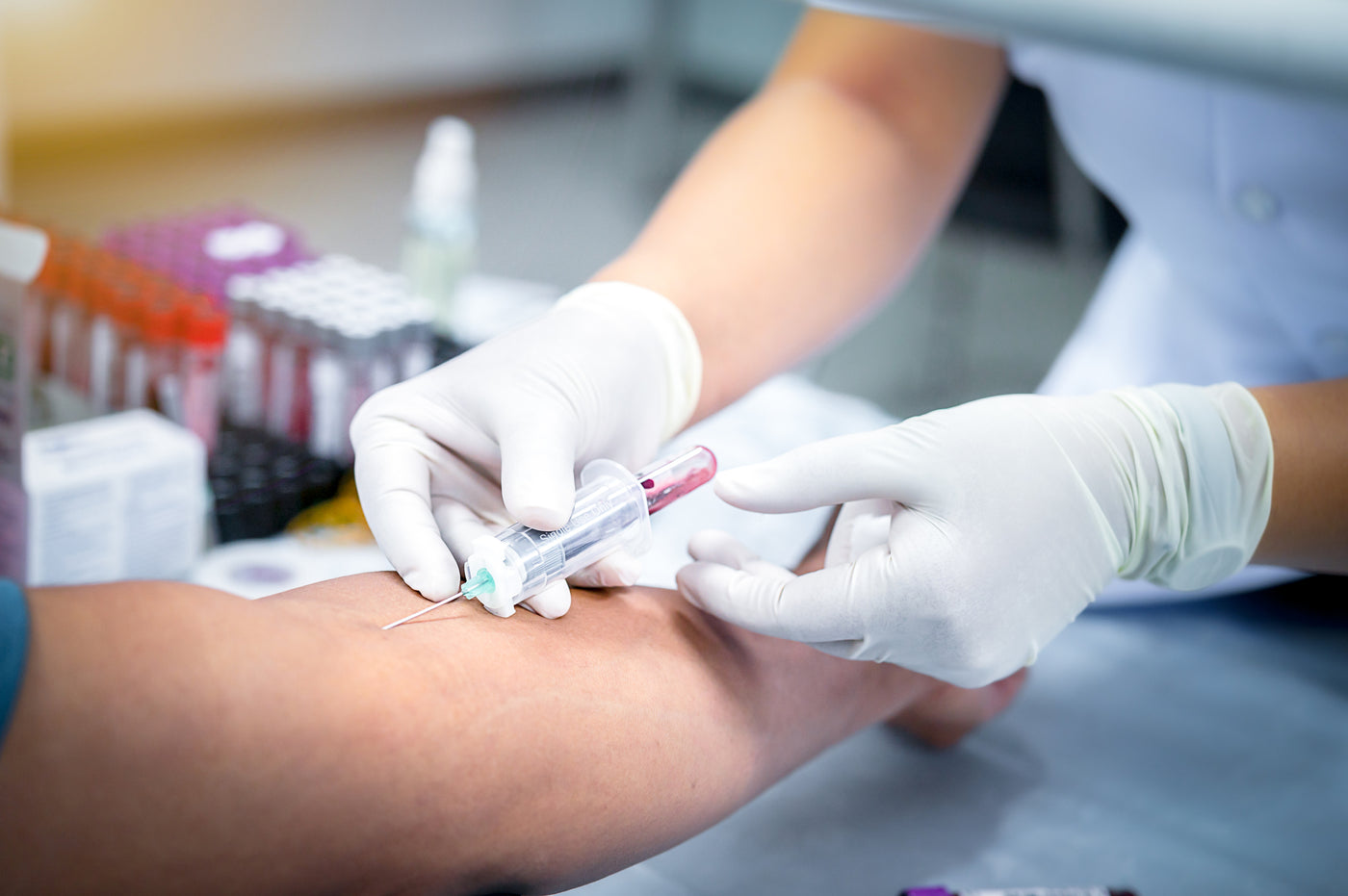 Nurse collecting blood sample during home visit for private testing